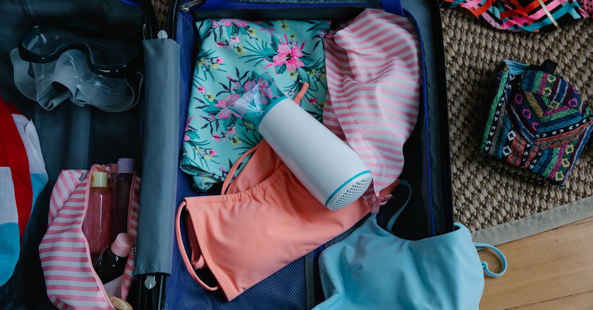 Packed suitcase open with summer travel essentials including swimwear